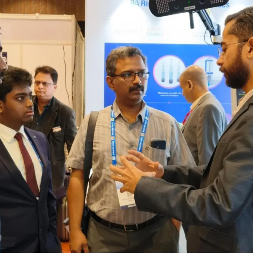 A presenter explaining cutting-edge navigation systems to attendees at a medical technology event.